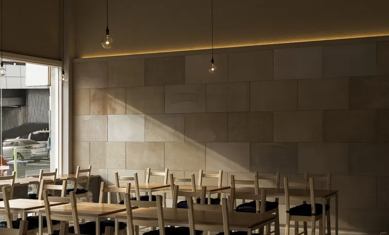 Dining room: lacquer paper wall panels in earth tones, pendant bulbs, linear light, timber furniture, afternoon sun