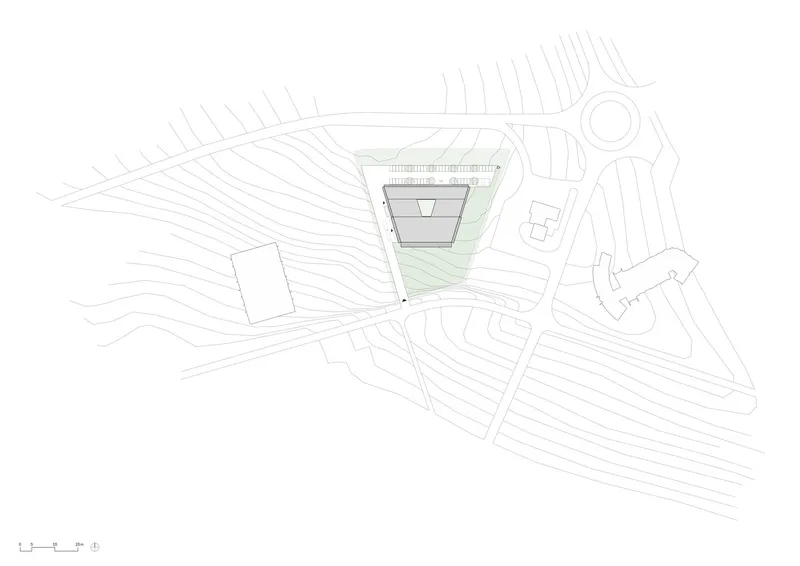 Site plan drawing showing the angular building footprint with topographic contours and access roads