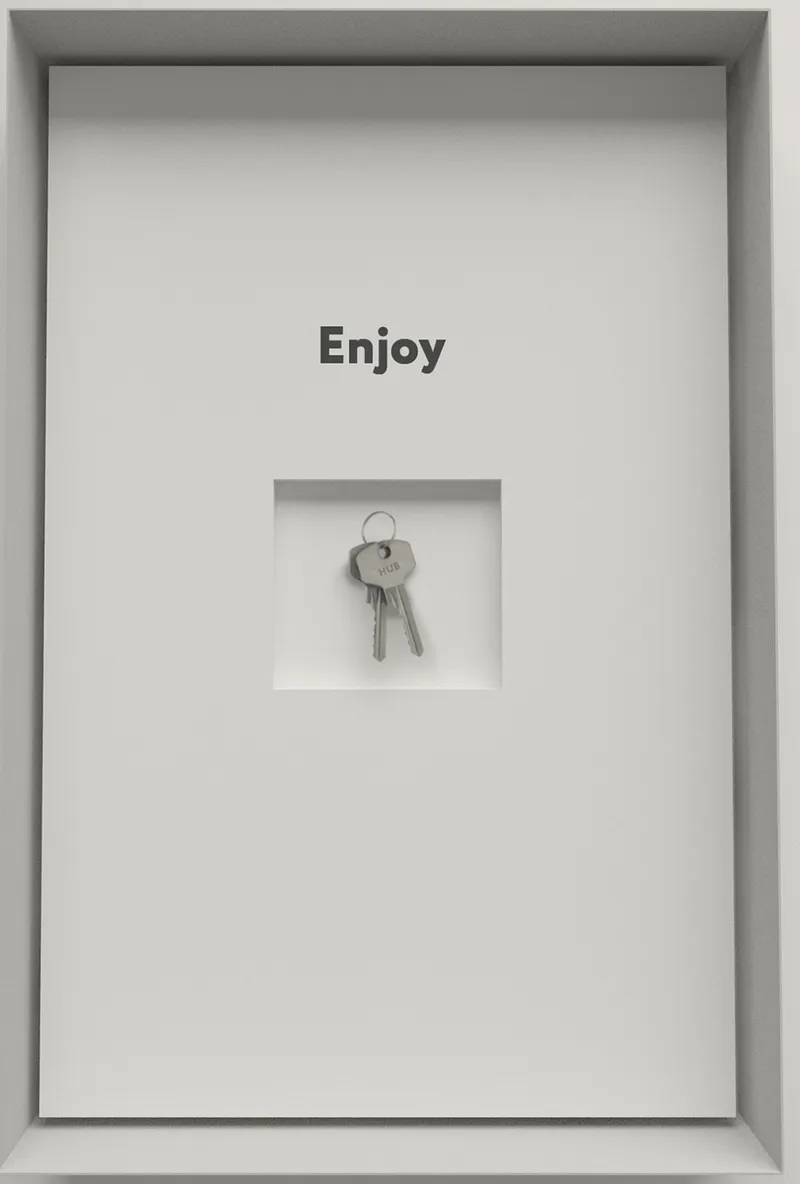 Move-in moment: a white box with 'Enjoy' printed above a recessed niche containing a set of keys for the new resident