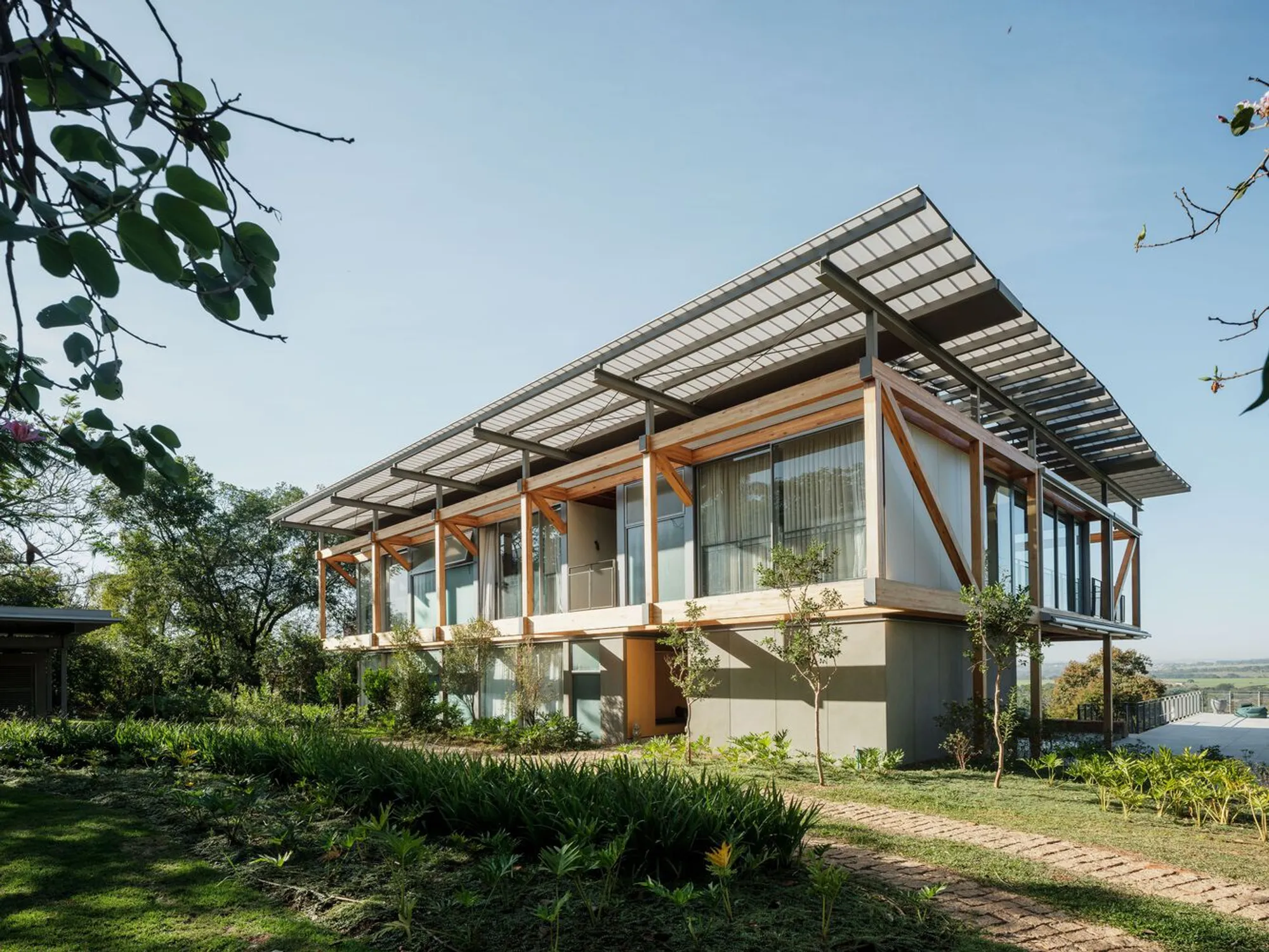 Andrade Morettin Lifts a Timber-Framed House Above the Brazilian Countryside on Solar Canopies