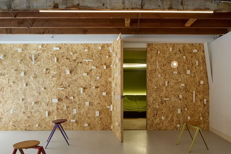 Interior workspace with movable oriented strand board walls and exposed timber ceiling beams