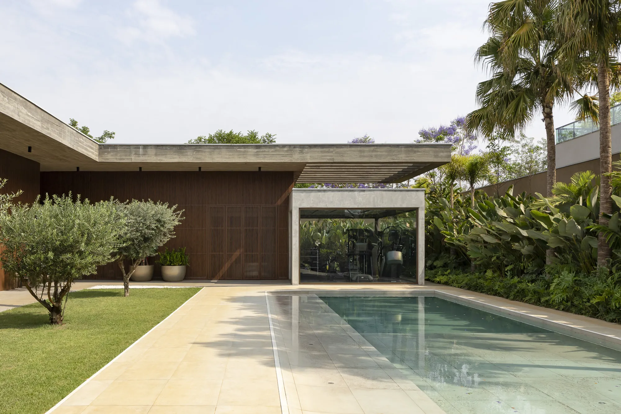 Rafael Granero Wraps a Feng Shui Courtyard House in Timber, Gabion, and Concrete in Brazil