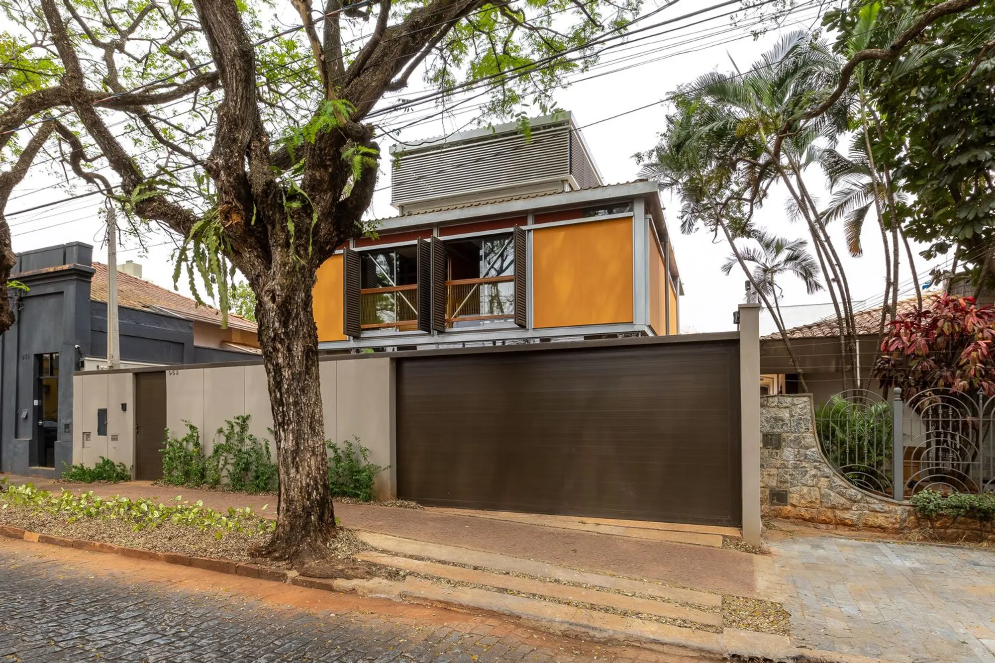 JBMC Arquitetura Lifts a Bold Orange Volume Above the Trees in Araraquara