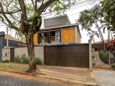 JBMC Arquitetura Lifts a Bold Orange Volume Above the Trees in Araraquara