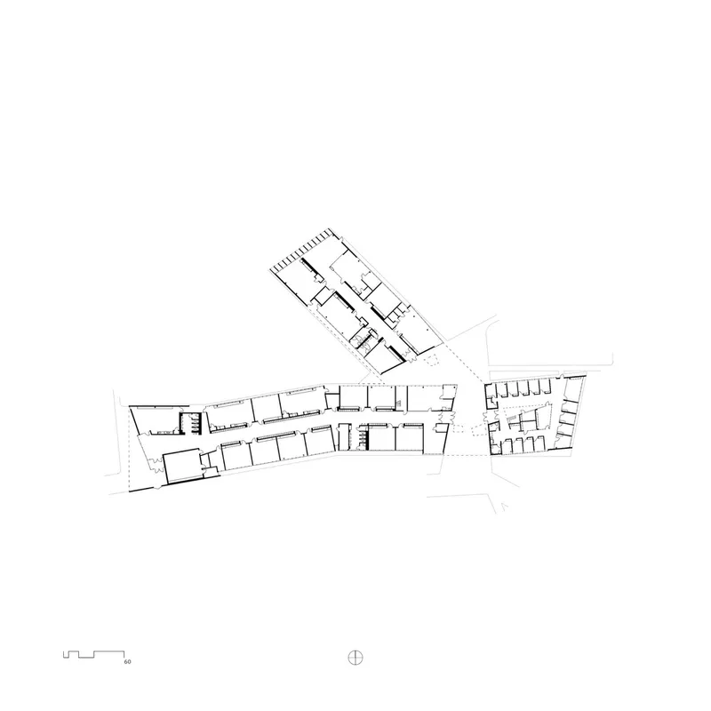 Floor plan drawing displaying three angled wings radiating from a central circulation spine with distributed rooms