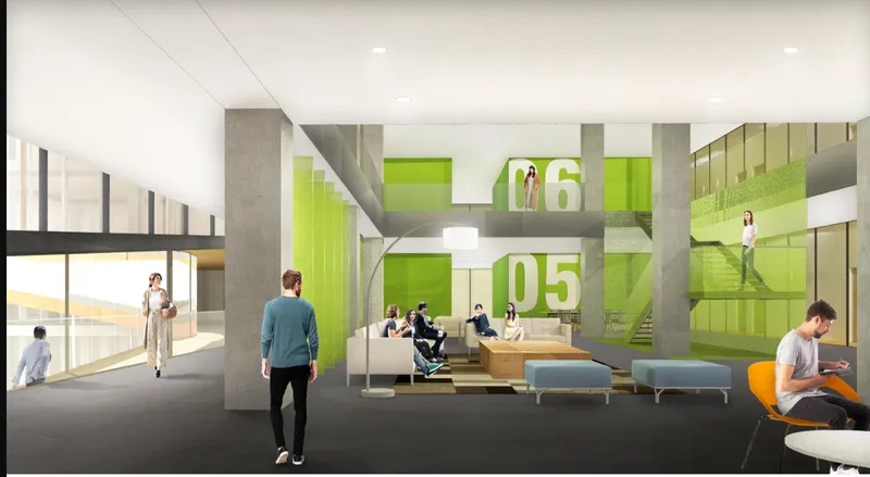 Double-height lobby with concrete columns, lime green partition walls marked with floor numbers, and scattered seating