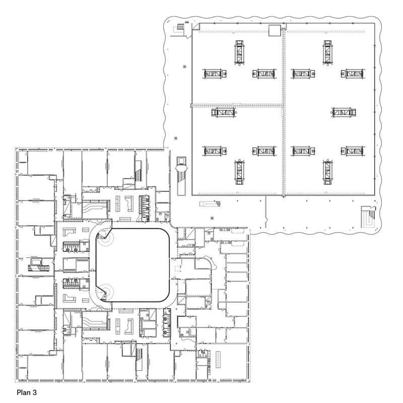 Floor plan drawing showing a central courtyard surrounded by classroom wings and a large sports hall