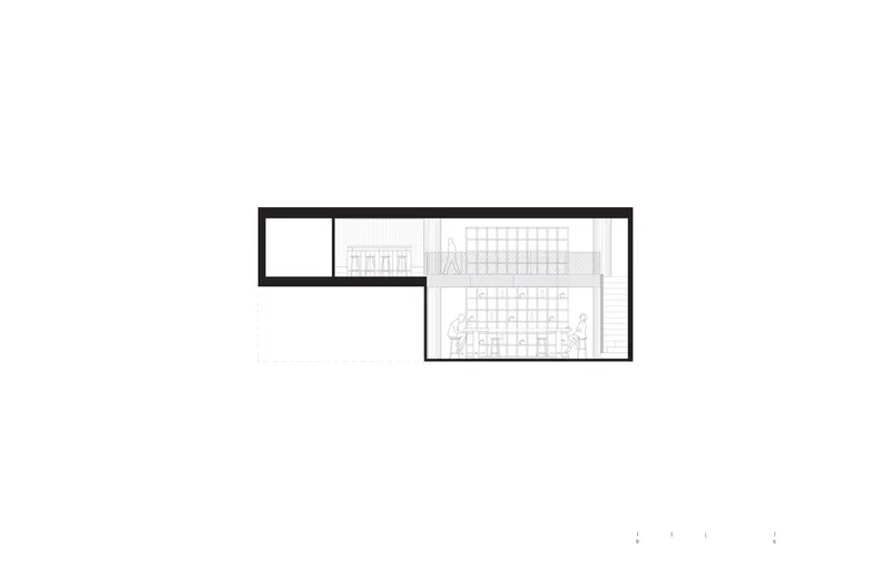Floor plan drawing displaying an L-shaped layout with gridded workspace and staircase