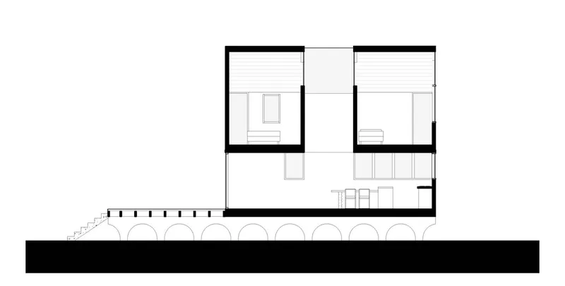 Section drawing revealing split-level rooms with built-in furniture and the structure's arched base