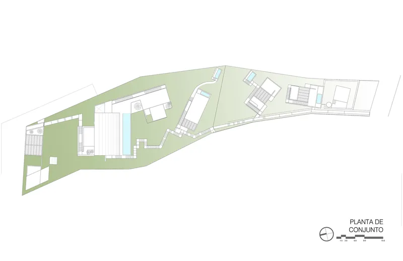 Site plan drawing showing multiple buildings arranged along a sloping coastal parcel with green zones