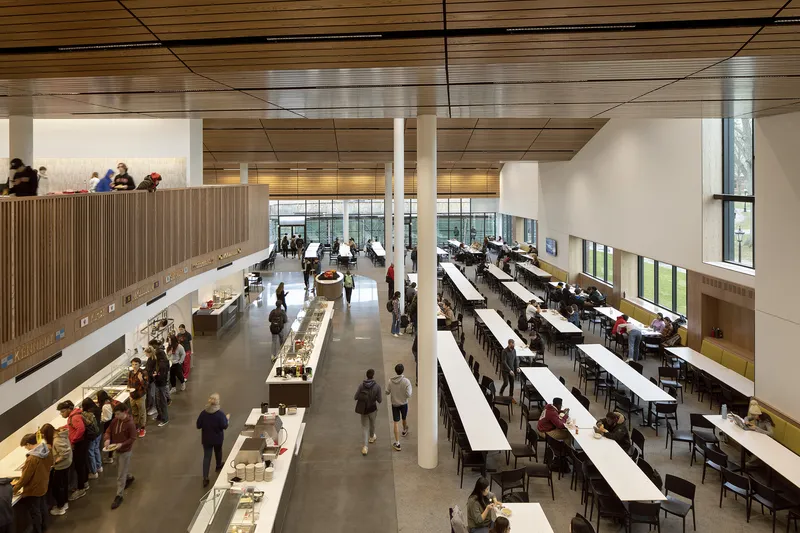 Aerial view of the cafeteria showing rows of long tables and food service counters