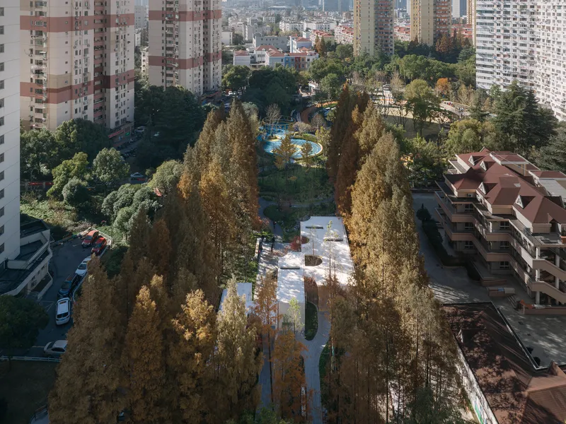 Elevated view of the tree-lined park paths connecting the plaza spaces between residential towers