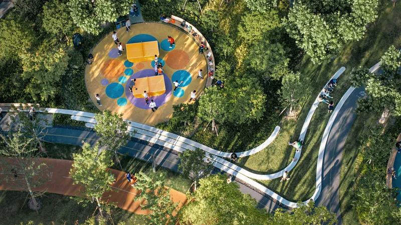 Overhead view of the circular play area with colorful surfacing surrounded by white canopy structure