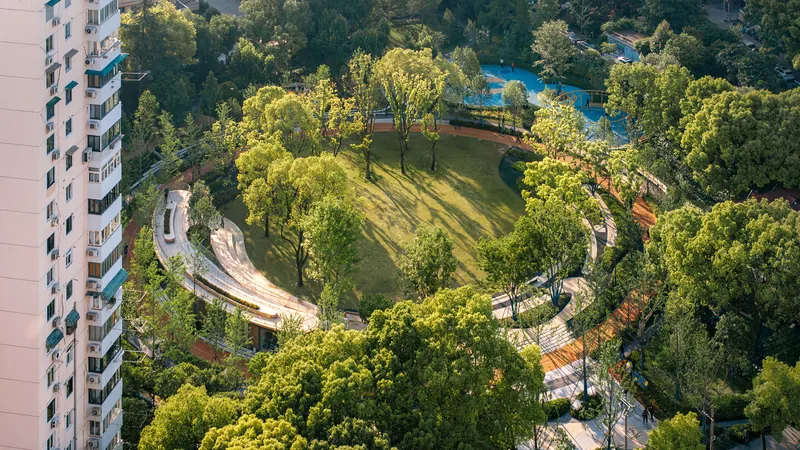 Aerial view of the circular landscaped courtyard with a curved canopy and central lawn surrounded by mature trees