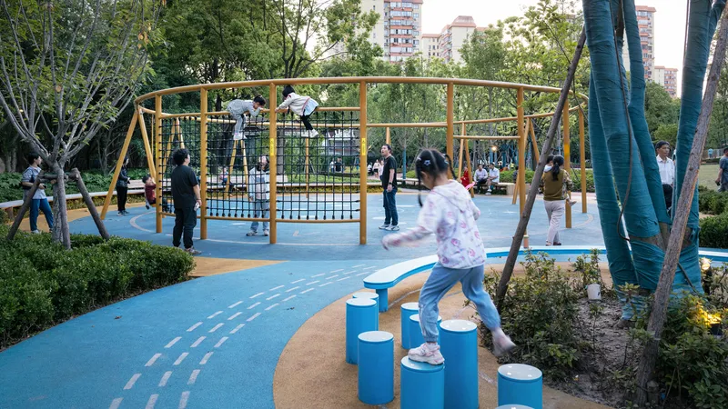 Children's play area with yellow tubular climbing frame and blue stepping disc path