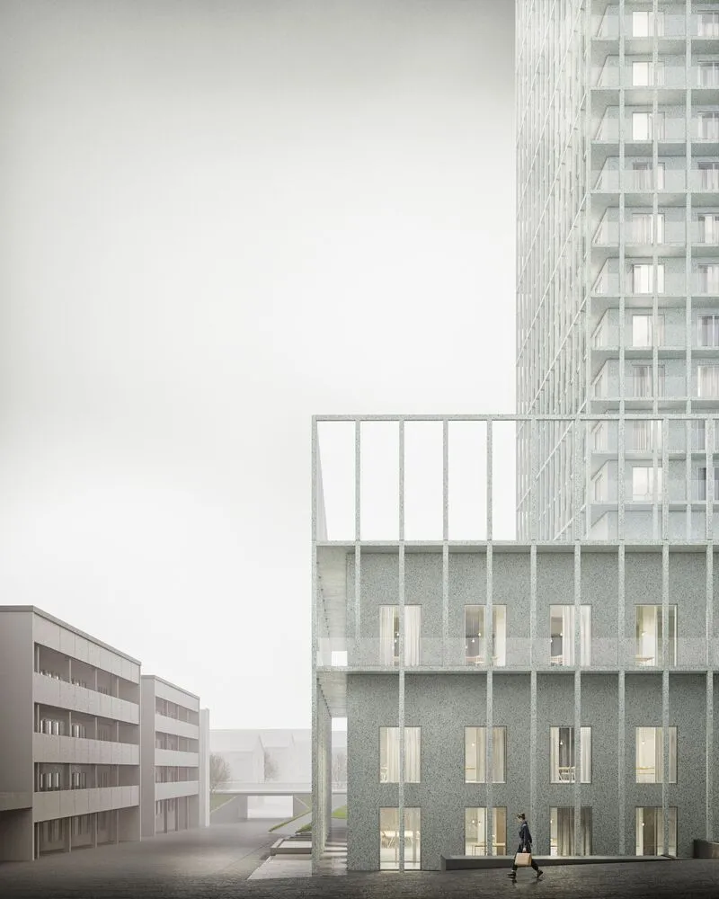 Close-up of the base showing glass balconies and textured concrete wall at dusk