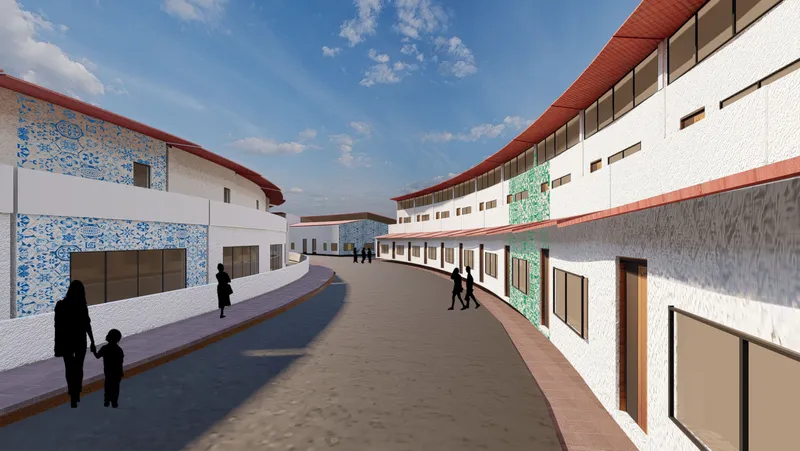 Curving pedestrian lane flanked by white stucco facades with terracotta roof canopies casting afternoon shadows