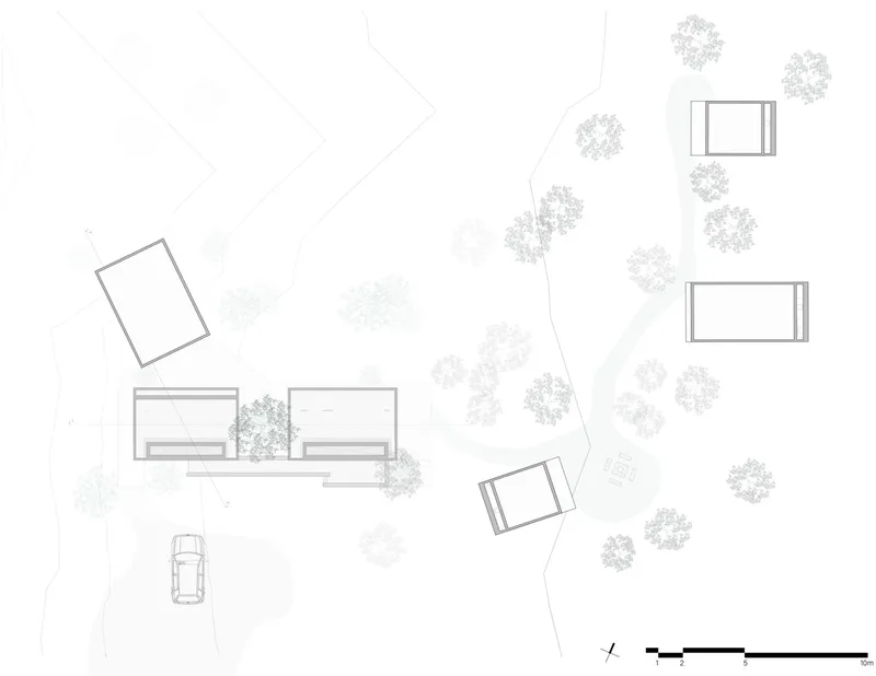 Site plan drawing showing rectangular volumes distributed among trees along a curving path