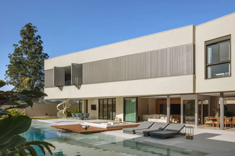 Rear facade with cantilevered upper floor and pool terrace framed by eucalyptus trees