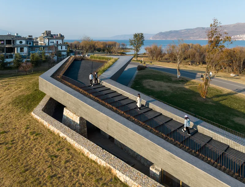 Aerial view of reflecting pools and central staircase with visitors walking along the water edges