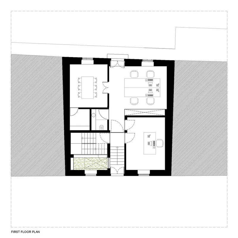 First floor plan drawing showing open living and dining areas with central staircase and small planted terrace