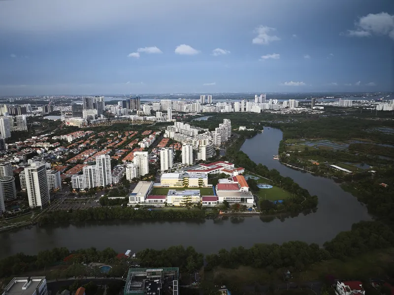 Aerial view of the campus bordered by a winding river and residential towers