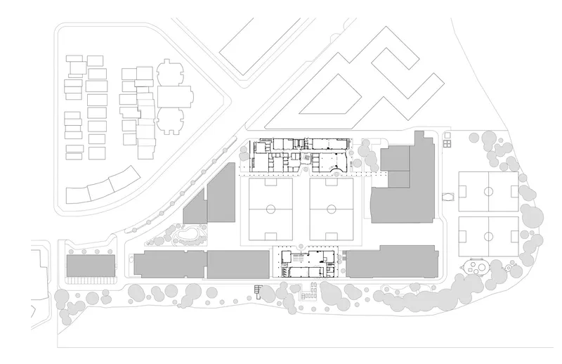 Site plan drawing showing campus buildings organized around sports fields and landscaped areas