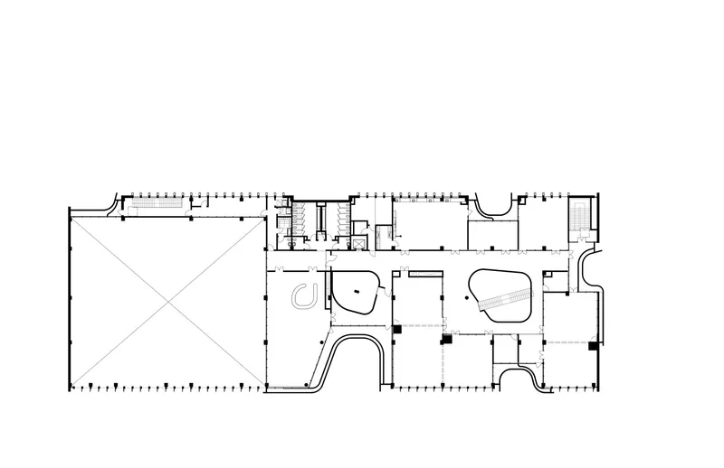 Floor plan drawing showing an open courtyard space and curvilinear interior rooms with diagonal structural elements