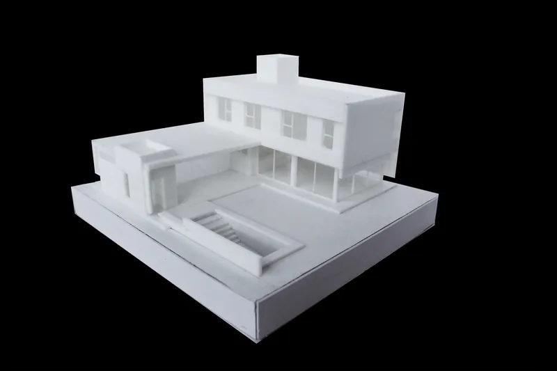 Physical model showing two-story residence with cantilevered volume and courtyard pool