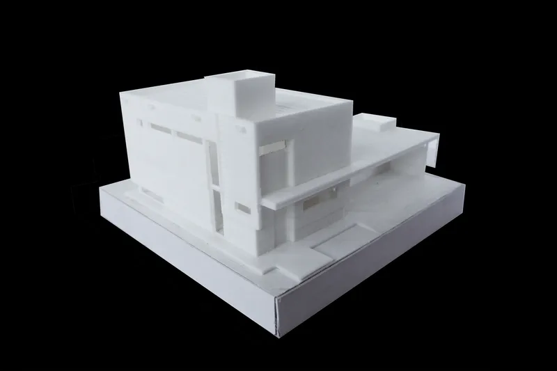 Physical model from the opposite corner showing stepped massing and glazed facades