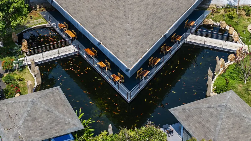 Top-down view of the V-shaped cantilevered dining terrace over symmetrical koi ponds