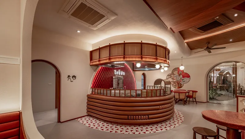 Circular service counter with horizontal timber slats beneath a suspended timber ring and coffered ceiling