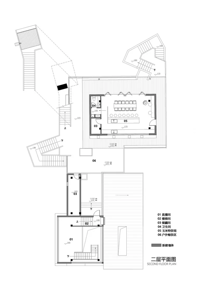 Second floor plan drawing showing a central room with dining table and three connected stair towers