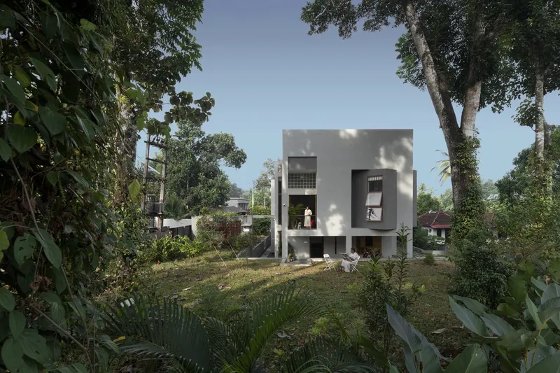 Three-storey white stucco volume with square openings set among mature trees and tropical vegetation