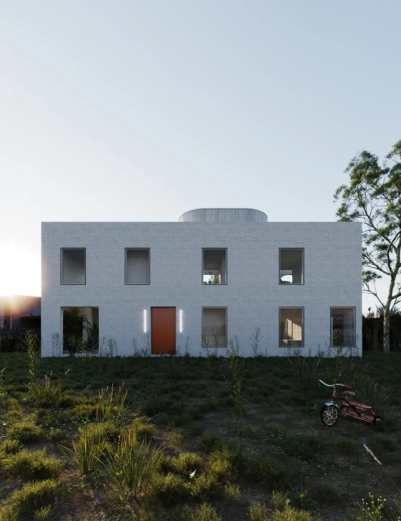 White brick facade with cylindrical rooftop element at sunset with a bicycle in the foreground