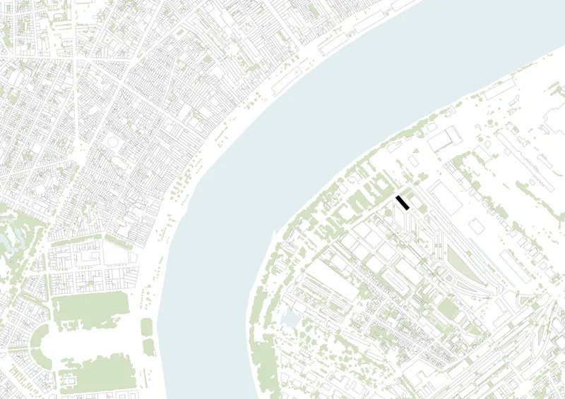 Site plan drawing showing a narrow building footprint between dense urban fabric and a curving waterfront
