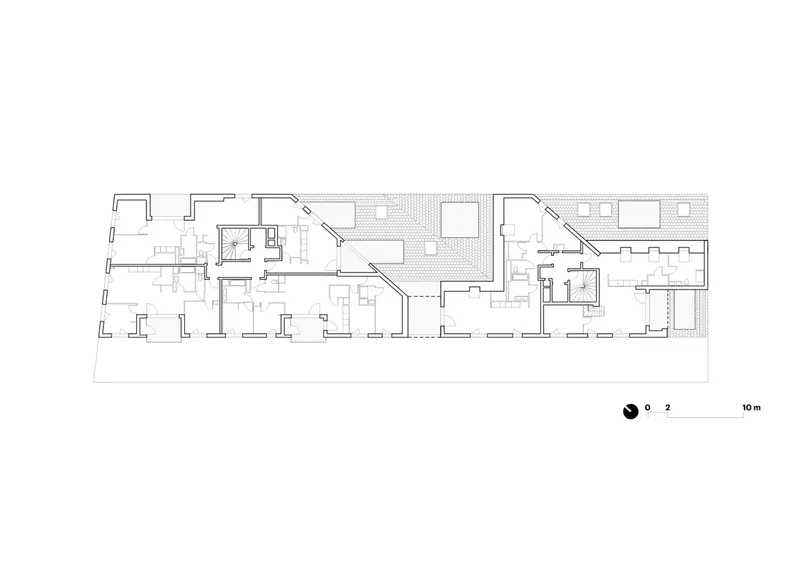 Ground floor plan showing a central courtyard flanked by two staircases and rows of residential units