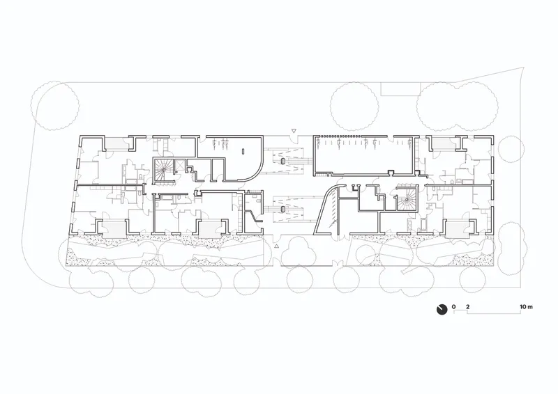 Floor plan drawing depicting residential units with outdoor terraces and landscaped perimeter with trees