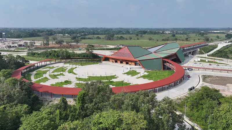 Elevated view of the curved red colonnade enclosing the forecourt with newly planted trees