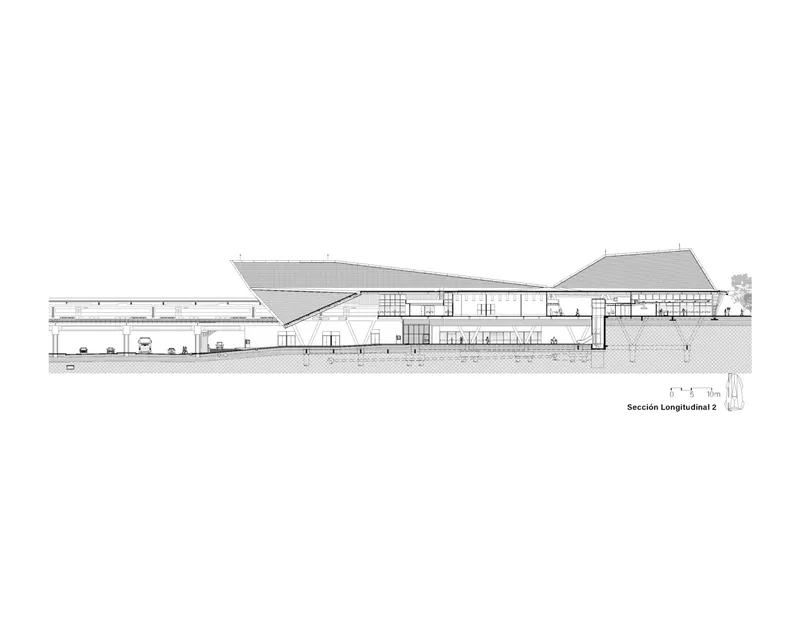 Longitudinal section drawing revealing interior spatial volumes with angular roof forms and multilevel program