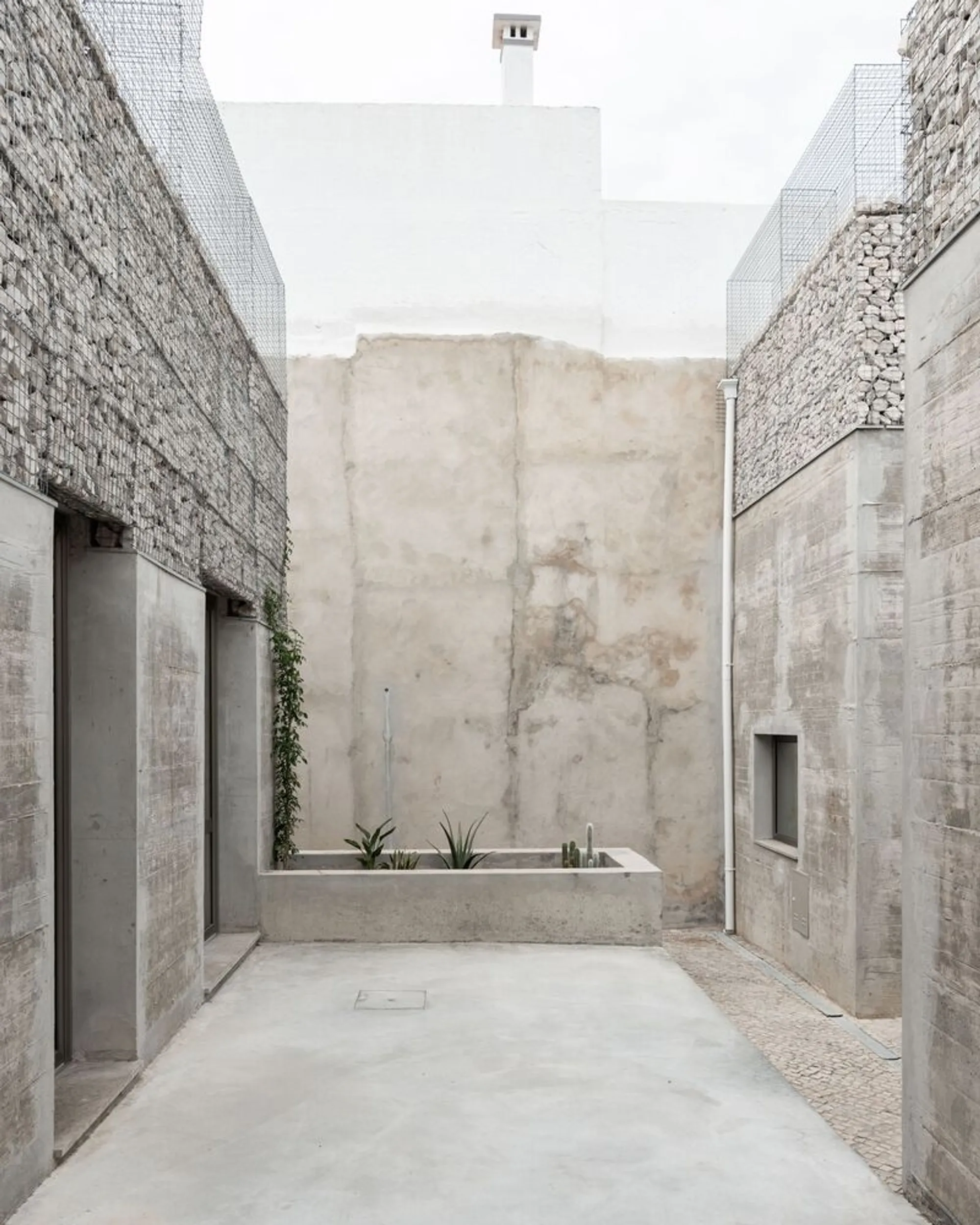Corpo Atelier Dissolves Concrete Walls into Air Across Three Courtyard Façades in Faro