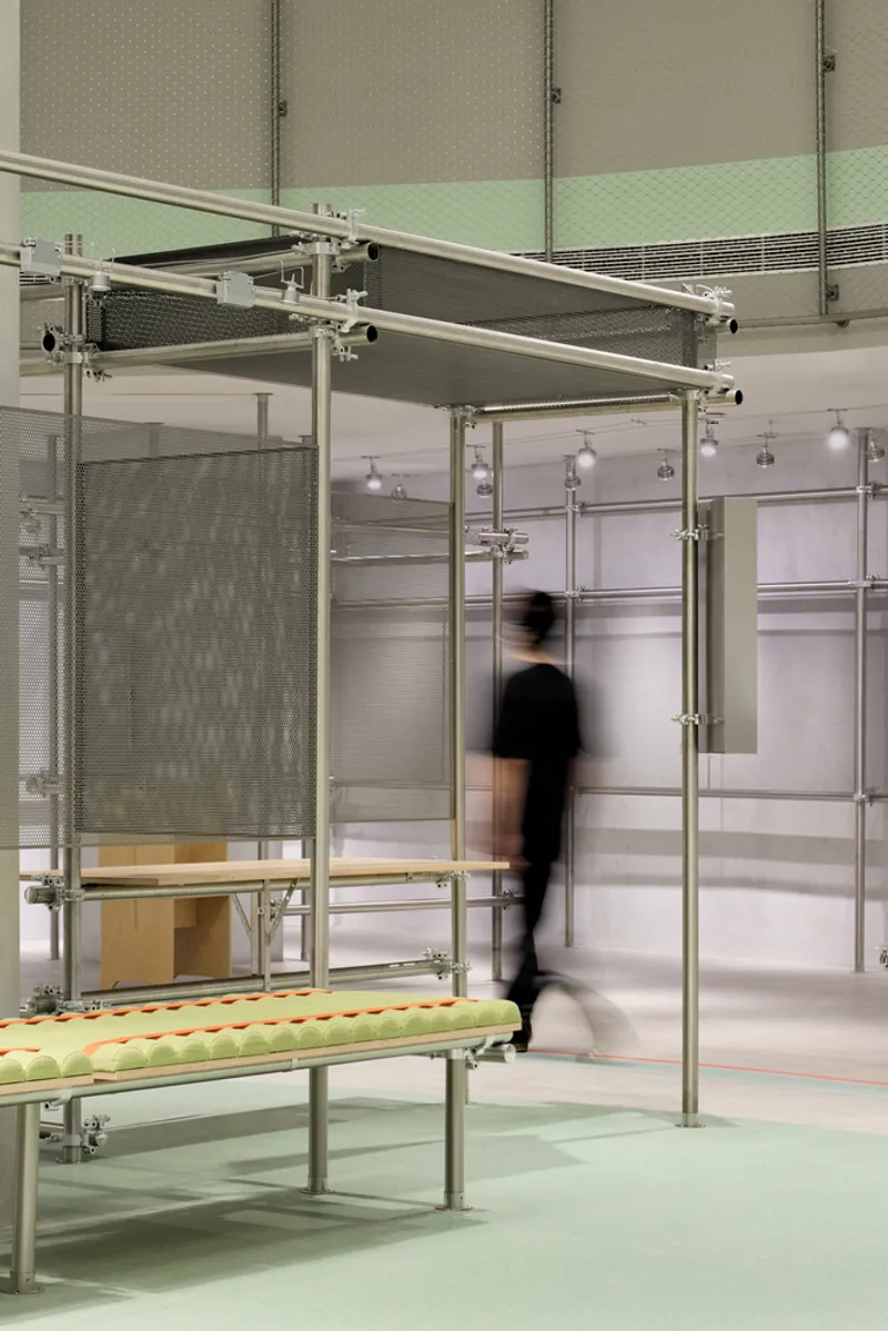 Freestanding metal frame with mesh screen and wooden bench below an adjustable canopy