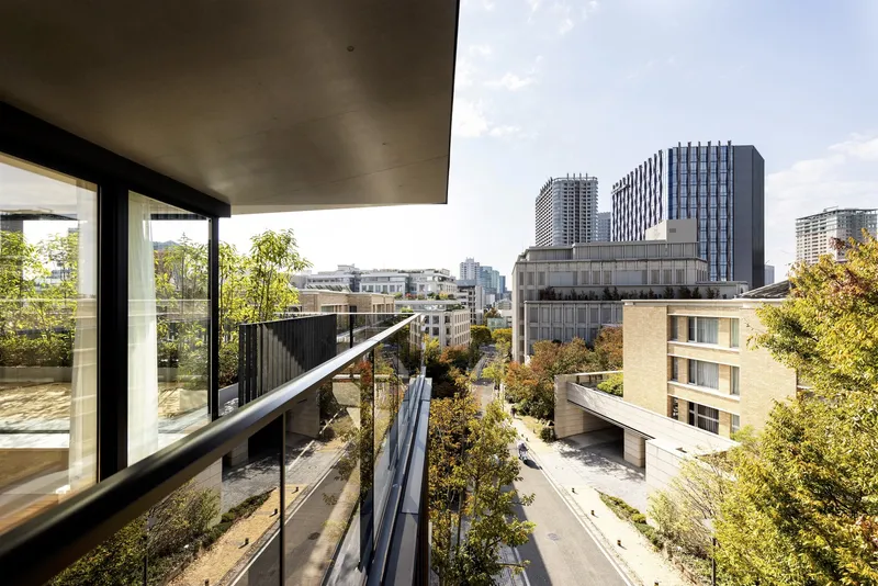 View from an upper terrace across the landscaped courtyard toward the surrounding urban skyline