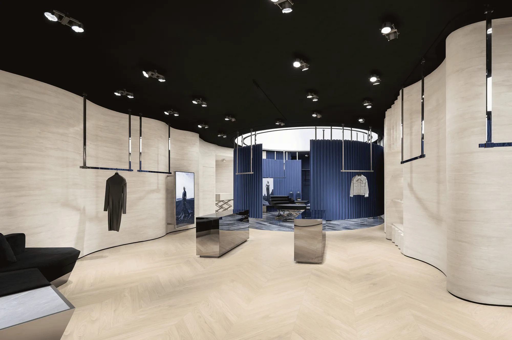 SLT Design Wraps a Hong Kong Boutique in Theatrical Blue Curtains and Rotating Stages