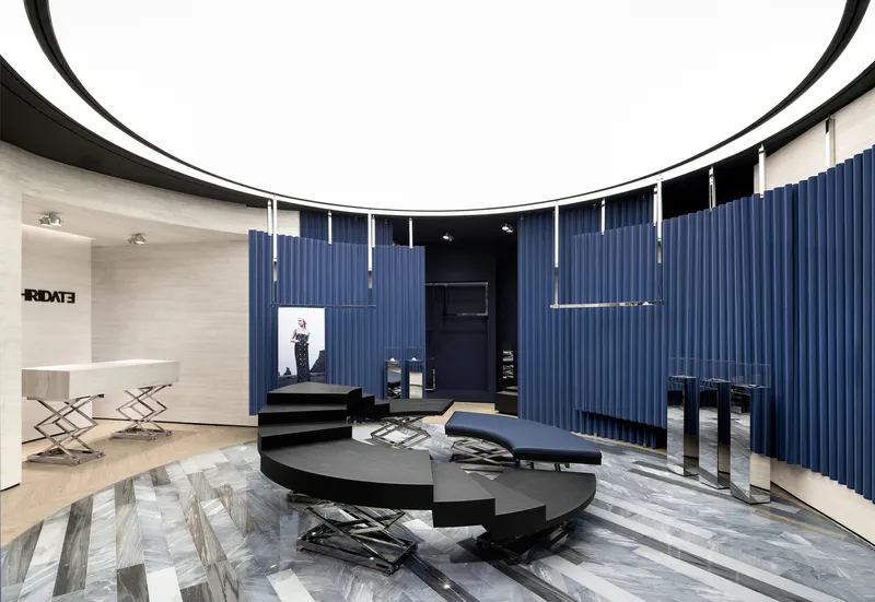 Curved seating area with black cantilevered steps, patterned marble floor and vertical blue fabric panels