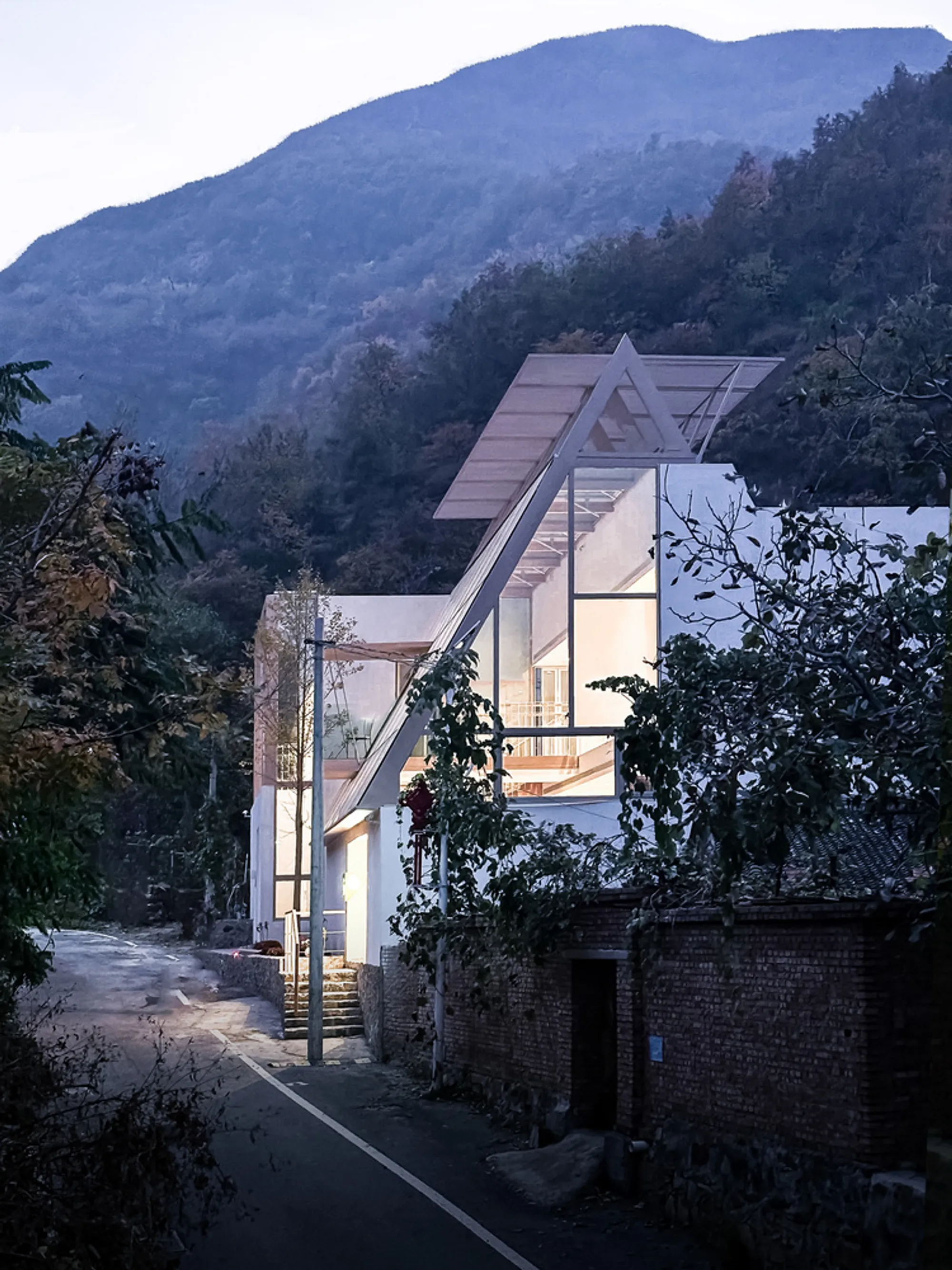 Brick&Cube Architects Nest a Timber Guesthouse into a Chinese Hillside Forest