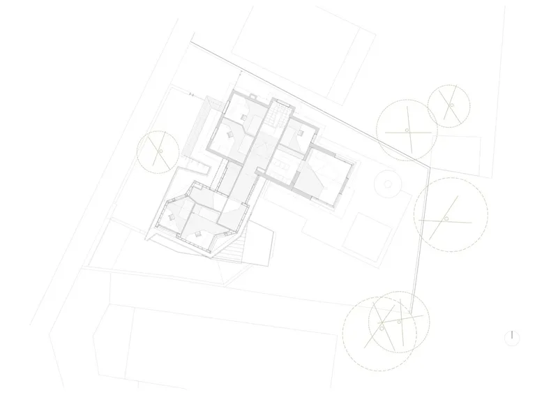Site plan drawing showing angled building footprint with interior rooms and circular tree canopies