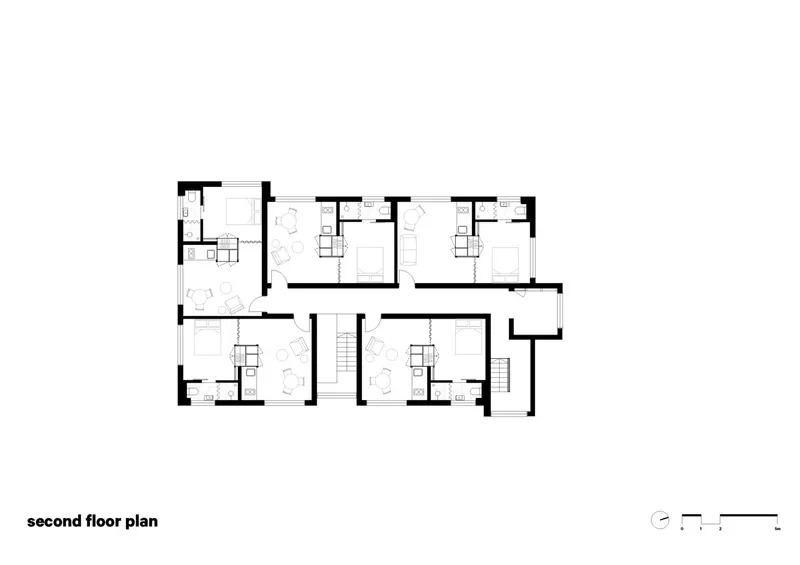 Second floor plan drawing depicting a mirrored layout of units with double stairwells