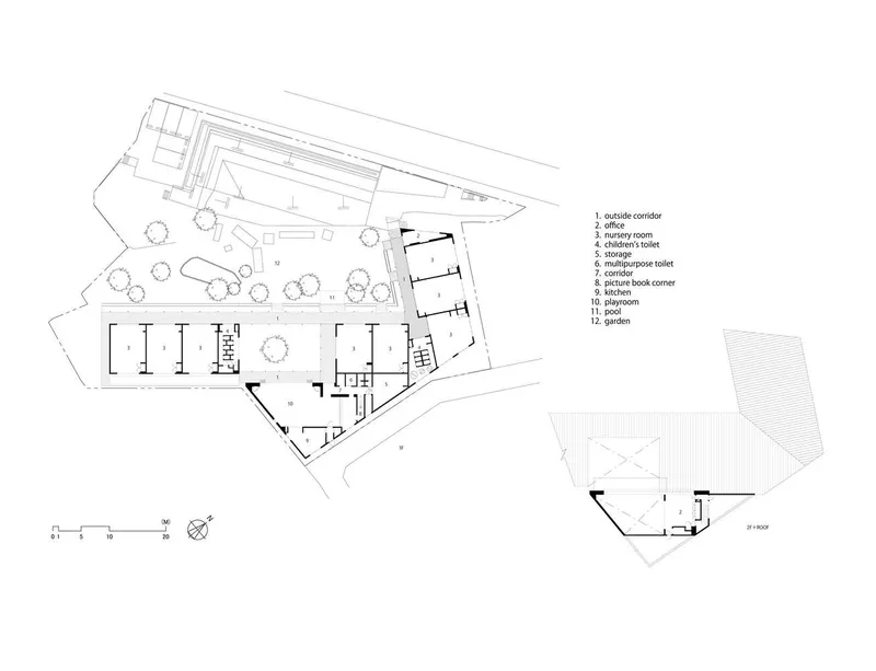 Floor plan drawing showing angled building footprint with labeled rooms, surrounding landscape, and detached structure