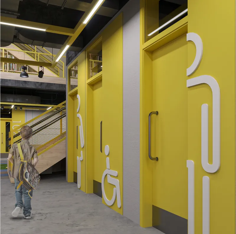 Yellow painted restroom doors with white accessibility pictograms and a child walking past